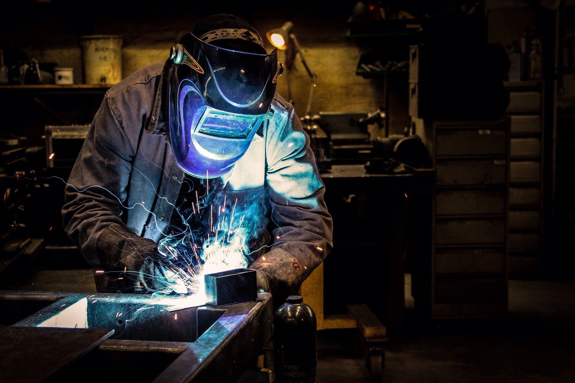 Welder Welding At Workshop